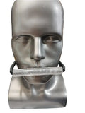 manniquin wearing a tubula piece of acrylic in his mouth to keep him quiet