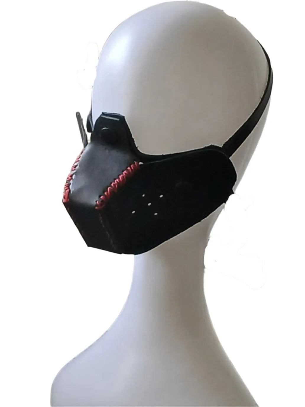 Black mask with red accents on a mannequin head against a white background
