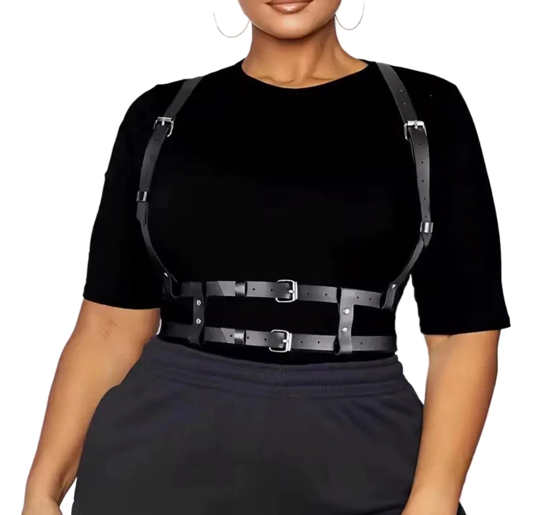A black harness going over her shoulders, that has two separate waist belts